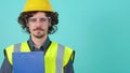 Young arhitect with safety glasses and helmet that is looking at camera.