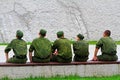 Young army men sitting on a bench