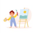 Young Artist boy is painting on canvas holding a brush and palette of colors Royalty Free Stock Photo