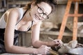 Young artist moulding raw clay in art studio Royalty Free Stock Photo