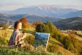 Young artist painting an autumn landscape Royalty Free Stock Photo