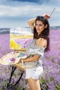 Young artist painting in lavender field