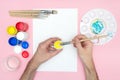 Young artist paints with watercolors. Workplace paintbrushes, different paints, and palette. Place for text. Royalty Free Stock Photo