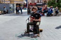 Young artist is playing electric guitar in Leicester Square in London