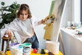 Young artistic girl choosing paint