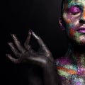 Young artistic woman in black paint and colourful powder. Glowing dark makeup. Creative body art on the theme of space Royalty Free Stock Photo