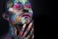 Young artistic woman in black paint and colourful powder. Glowing dark makeup. Creative body art on the theme of space Royalty Free Stock Photo