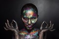 Young artistic woman in black paint and colourful powder. Glowing dark makeup. Creative body art on the theme of space Royalty Free Stock Photo