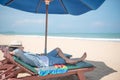 Young Asain man lying on beach bench Royalty Free Stock Photo