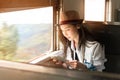 Young Asia backpacker woman travels by train Royalty Free Stock Photo