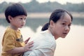 Young boy on back of his mother : Soft foucus Royalty Free Stock Photo