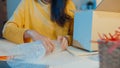 Young Asia businesswoman packing glass use bubble wrap for packing support damage fragile product in home office at night. Small Royalty Free Stock Photo