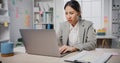 Young Asia businesswoman sitting on desk crazy with overworked stress angry massive work scream at office. Lady mad trouble of Royalty Free Stock Photo