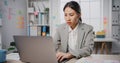 Young Asia businesswoman sitting on desk crazy with overworked stress angry massive work scream at office. Lady mad trouble of Royalty Free Stock Photo