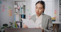 Young Asia businesswoman sitting on desk crazy with overworked stress angry massive work scream at office. Lady mad trouble of Royalty Free Stock Photo