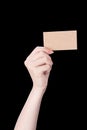 Young asia clean girl hand holding a blank kraft brown paper card template isolated on black background, clipping path, close up, Royalty Free Stock Photo