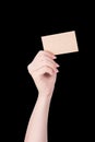 Young asia clean girl hand holding a blank kraft brown paper card template isolated on black background, clipping path, close up, Royalty Free Stock Photo