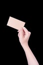 Young asia clean girl hand holding a blank kraft brown paper card template isolated on black background, clipping path, close up, Royalty Free Stock Photo