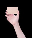 Young asia clean girl hand holding a blank kraft brown paper card template isolated on black background, clipping path, close up, Royalty Free Stock Photo