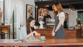 Young Asia freelance lady client talk dispute with millennial waitress feel dissatisfied with cafe bad service, mad disappointed