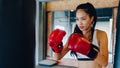 Young Asia lady kickboxing exercise workout punching bag tough female fighter practice boxing in gym fitness class. Sportswoman Royalty Free Stock Photo