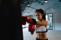 Young Asia lady kickboxing exercise workout punching bag tough female fighter practice boxing in gym fitness class. Sportswoman Royalty Free Stock Photo