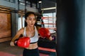 Young Asia lady kickboxing exercise workout punching bag tough female fighter practice boxing in gym fitness class. Sportswoman Royalty Free Stock Photo