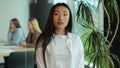 Young Asia lady standing in contemporary meeting room. Portrait of successful beautiful executive asian businesswoman Royalty Free Stock Photo