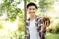 Young Asia man farmer holding grapes after harvest form vineyard, healthy fruit concept Royalty Free Stock Photo