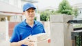 Young Asia postal delivery courier man in blue shirt handling parcel boxes for sending to customer at house and Asian female Royalty Free Stock Photo