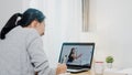 Young Asia teen girl university student using laptop computer distance learn lesson with female teacher remote teaching on Royalty Free Stock Photo