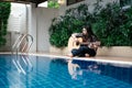 Young woman hold guitar classic in her hand and sitting beside p Royalty Free Stock Photo