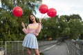 Young Asia woman holding red balloons