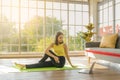 Young Asia woman practicing yoga lesson, breathing, meditating and watching videos on laptop in living room at home. Royalty Free Stock Photo