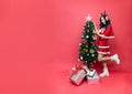 Young asia woman in red santy costume decorate the Christmas tree. New Year celebration. Christmas eve Royalty Free Stock Photo