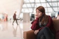 Young asia woman waiting boarding on aircraft in airport lounge Royalty Free Stock Photo