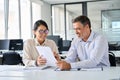 Diverse professional colleagues discussing financial papers working in office. Royalty Free Stock Photo