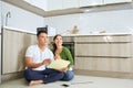 Young Asian Adult Couple Sitting on Floor and Planning New Home Design Royalty Free Stock Photo