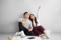 Young asian adult couple sitting on flor planning new home design. Royalty Free Stock Photo