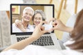 Young asian woman talking chatting with parents via video call using laptop computer