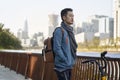 Young asian adult man with backpack and bicycle looking at view thinking Royalty Free Stock Photo