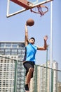 Young asian adult man dunking basketball Royalty Free Stock Photo