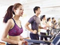 Asian young people working out on treadmill Royalty Free Stock Photo