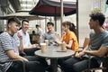 Young asian adults relaxing at outdoor coffee shop Royalty Free Stock Photo