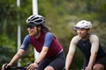 young asian adults riding bike on rural road Royalty Free Stock Photo