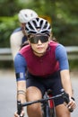 young asian adults riding bike on rural road Royalty Free Stock Photo