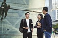 Young asian adults standing talking on street Royalty Free Stock Photo