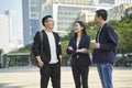 Young asian adults standing talking on street Royalty Free Stock Photo