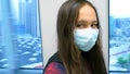Young Asian American girl wearing surgical mask