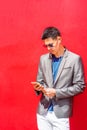 Young Asian American Man listening music on cell phone in New York City Royalty Free Stock Photo